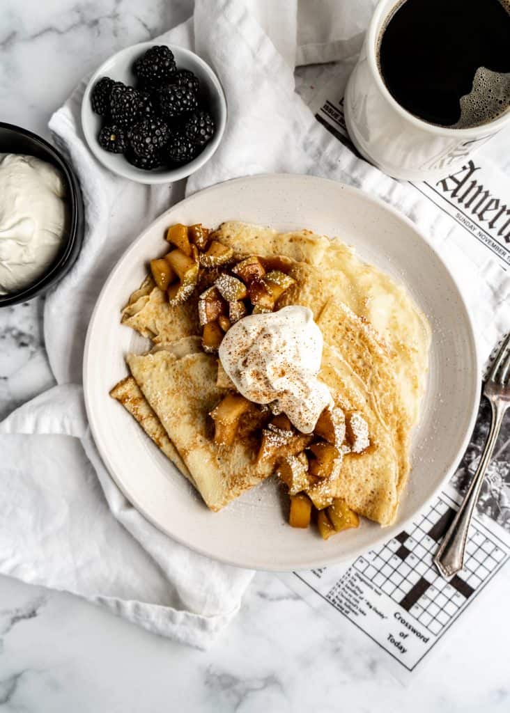 overhead shot of apple cinnamon crepes with whipped cream