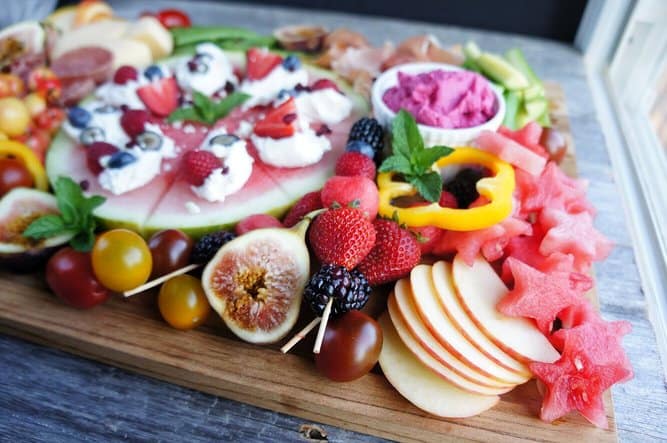 close up shot of figs and apples on fruit charcuterie board 