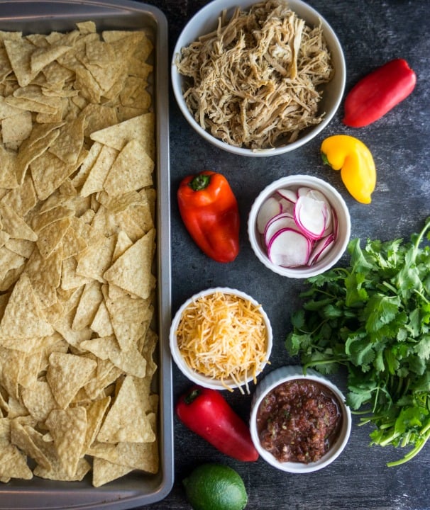 Game day snacks aren't complete without a big sheet pan of crispy cheesy goodness! Complete your tailgate menu with these pulled pork nachos. 