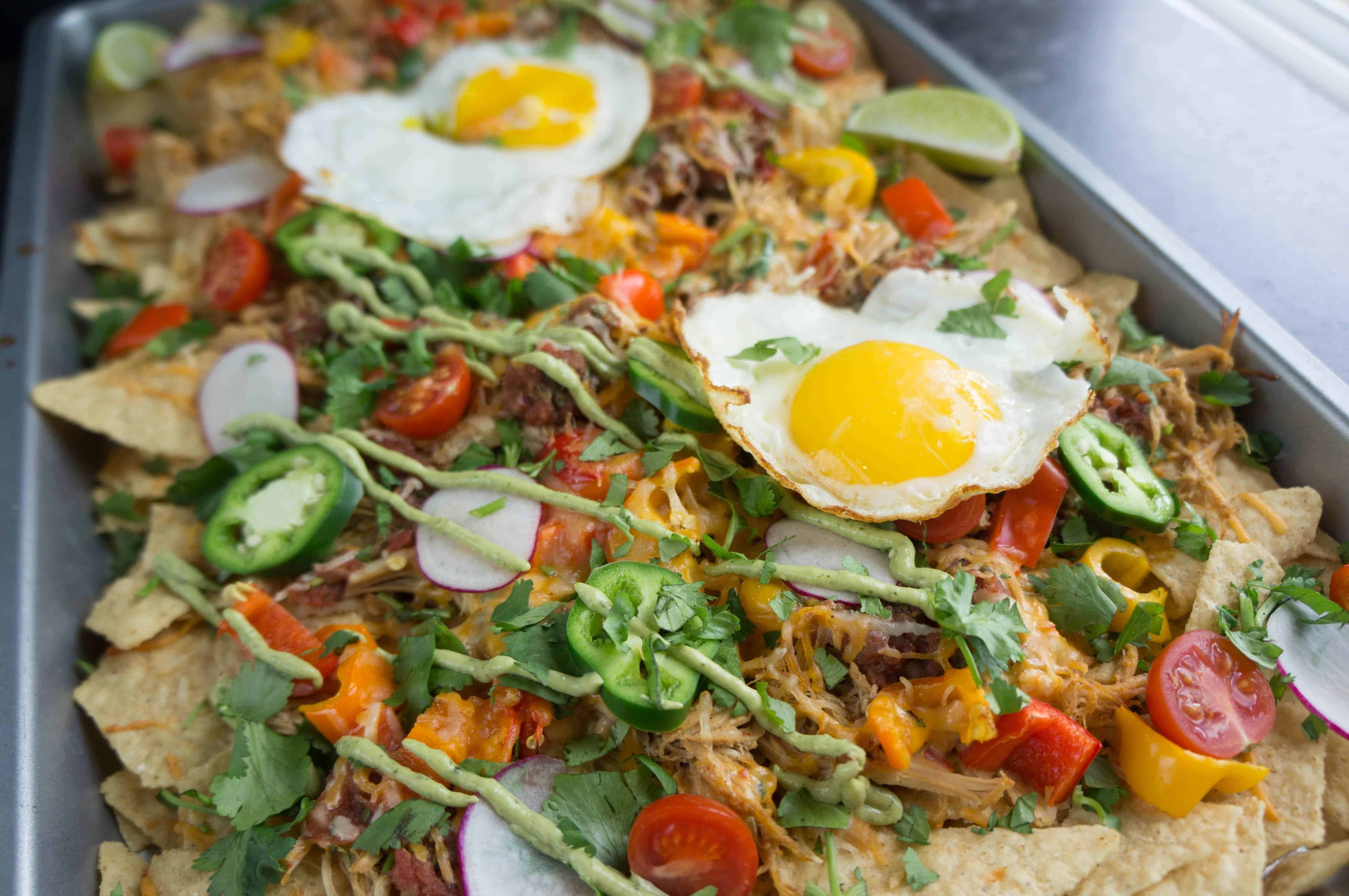 Game day snacks aren't complete without a big sheet pan of crispy cheesy goodness! Complete your tailgate menu with these pulled pork nachos. 