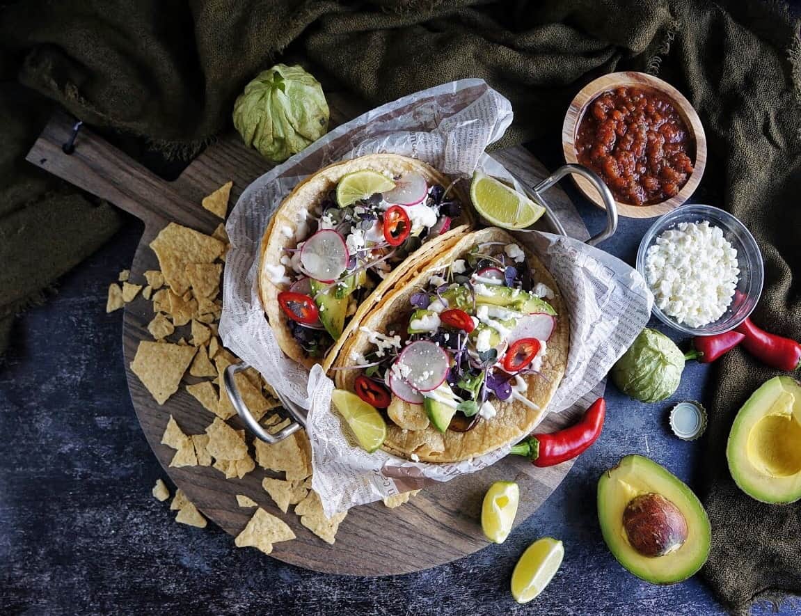 portobello mushroom tacos in a dish surrounded by salsa and avocado