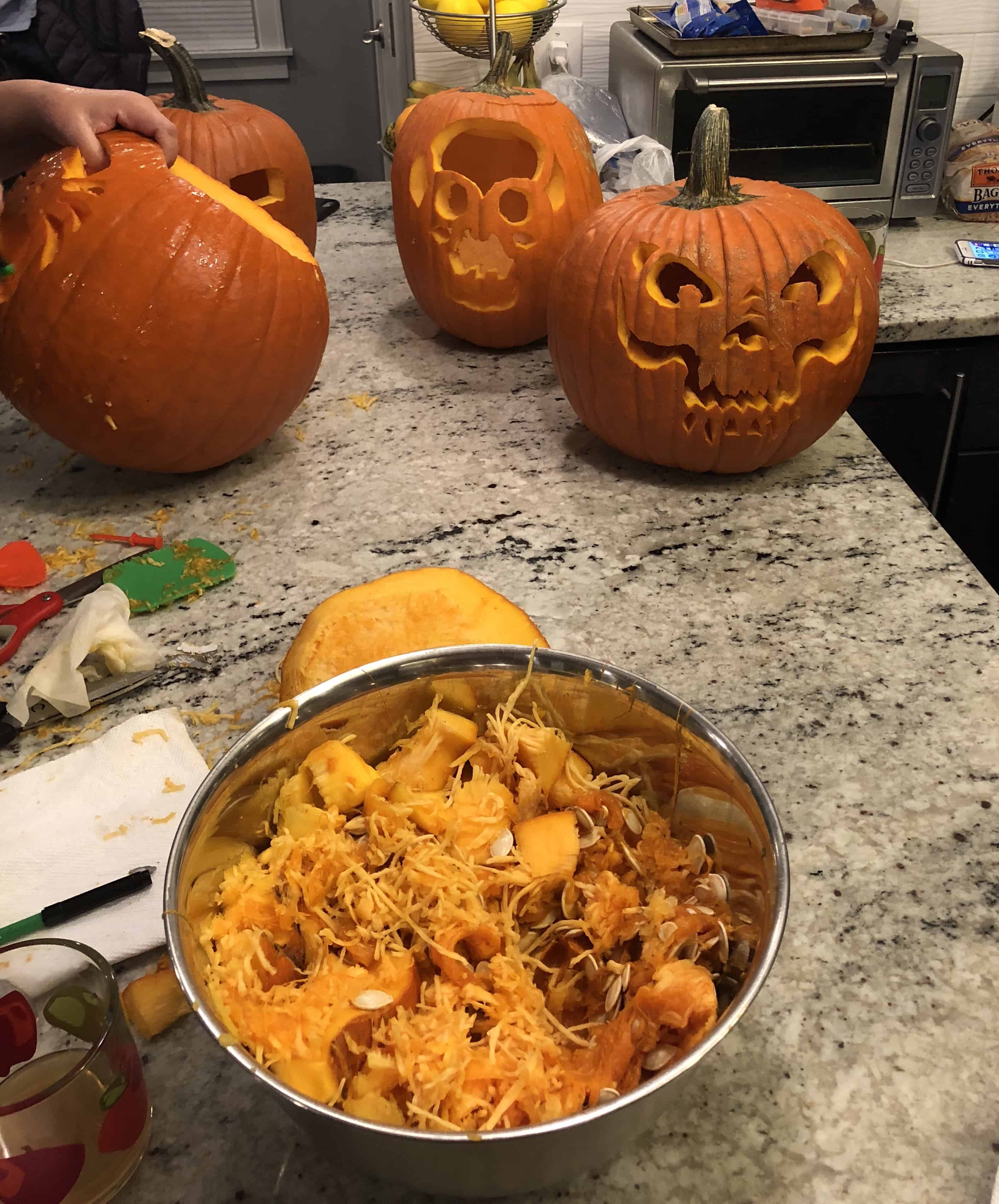 carved pumpkins and seeds in bowl