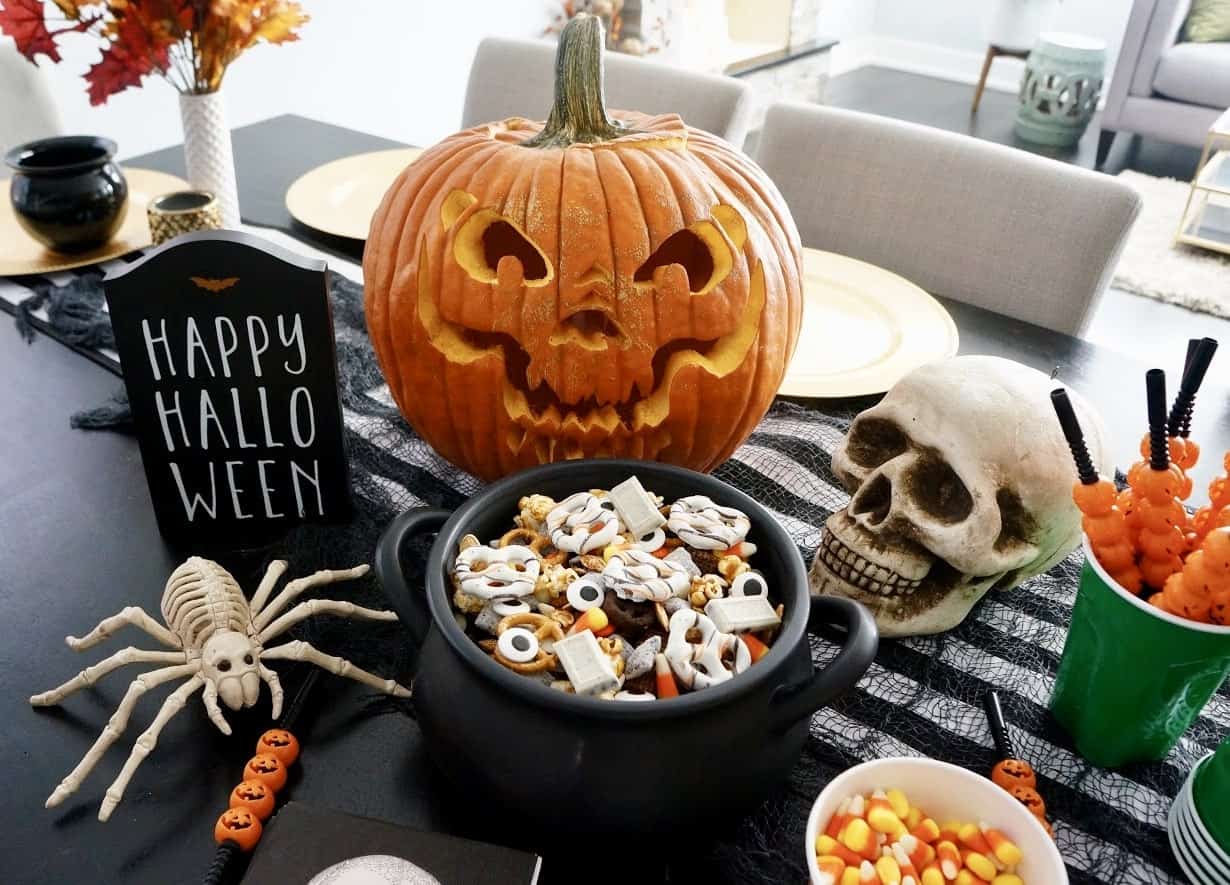 halloween trail mix on table with carved pumpkin