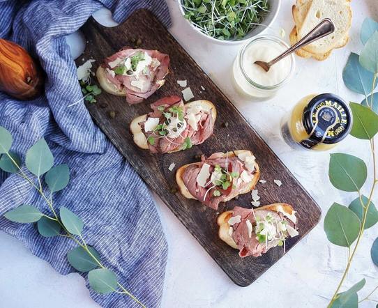 Need a simple yet elegant holiday appetizer? Look no further than this easy to make Roast Beef Crostini, perfect for parties! Roast Beef Crostini on serving platter overhead