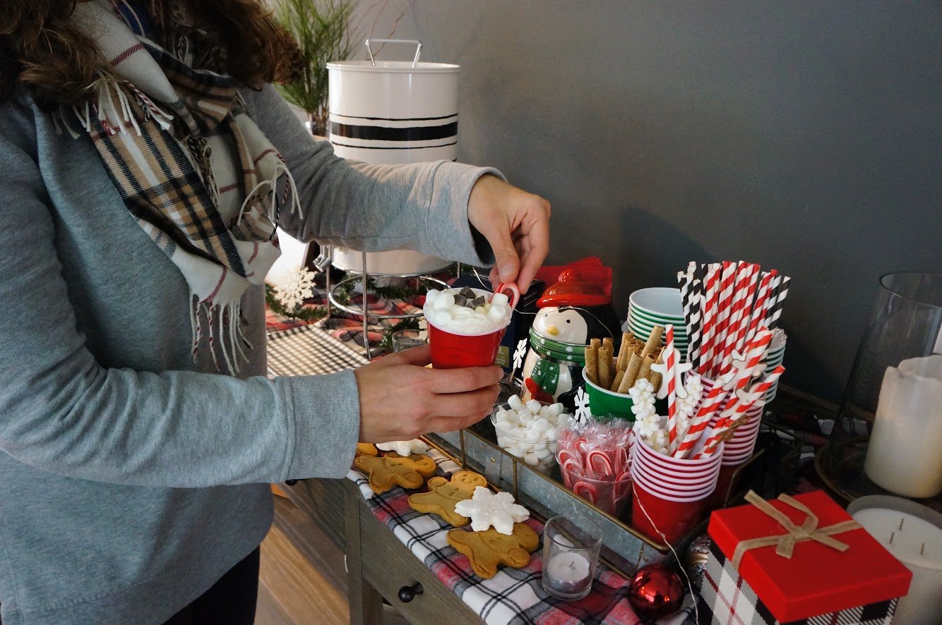 adding candy cane to hot cocoa