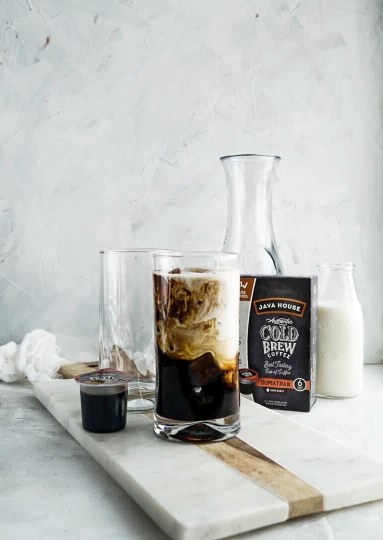 milk swirling in coffee glass with ice