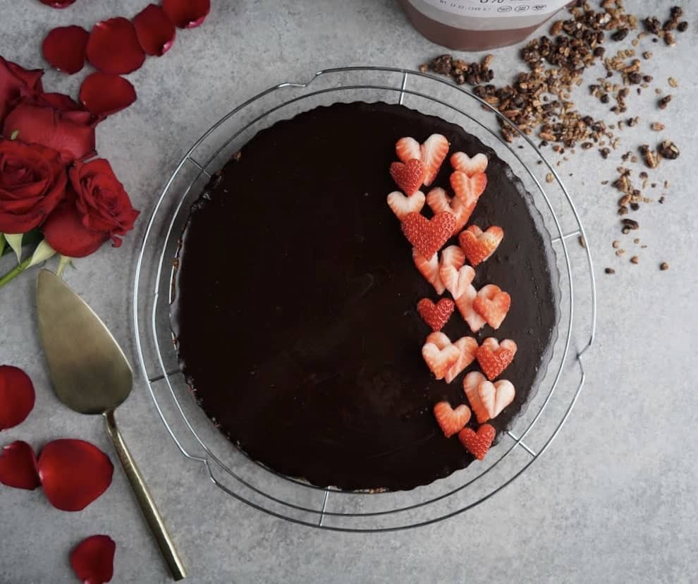 gluten free and vegan double chocolate tart with strawberries on top