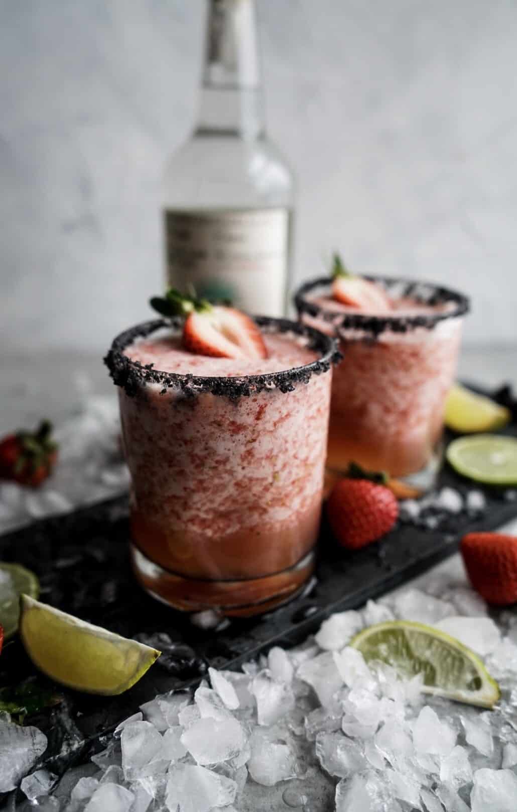 Strawberry Lime Margaritas garnished with salt and fresh strawberries