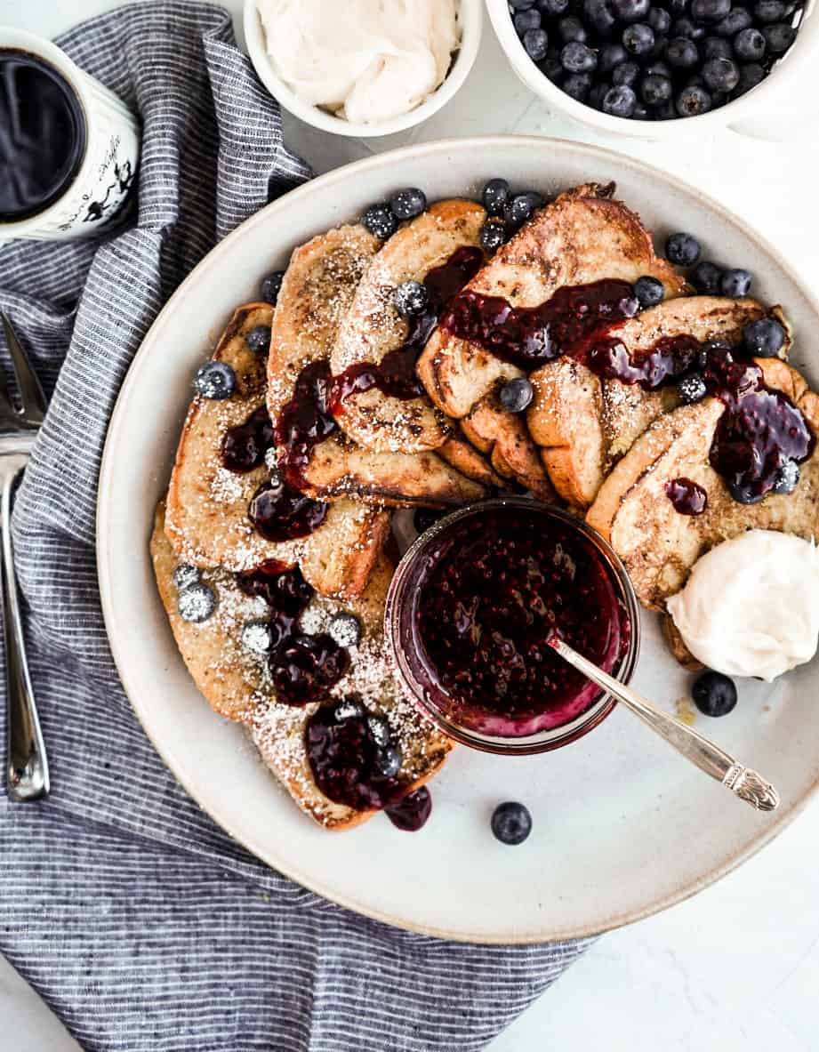 overhead shot of fluffy french toast with berry sauce and whipped mascarpone