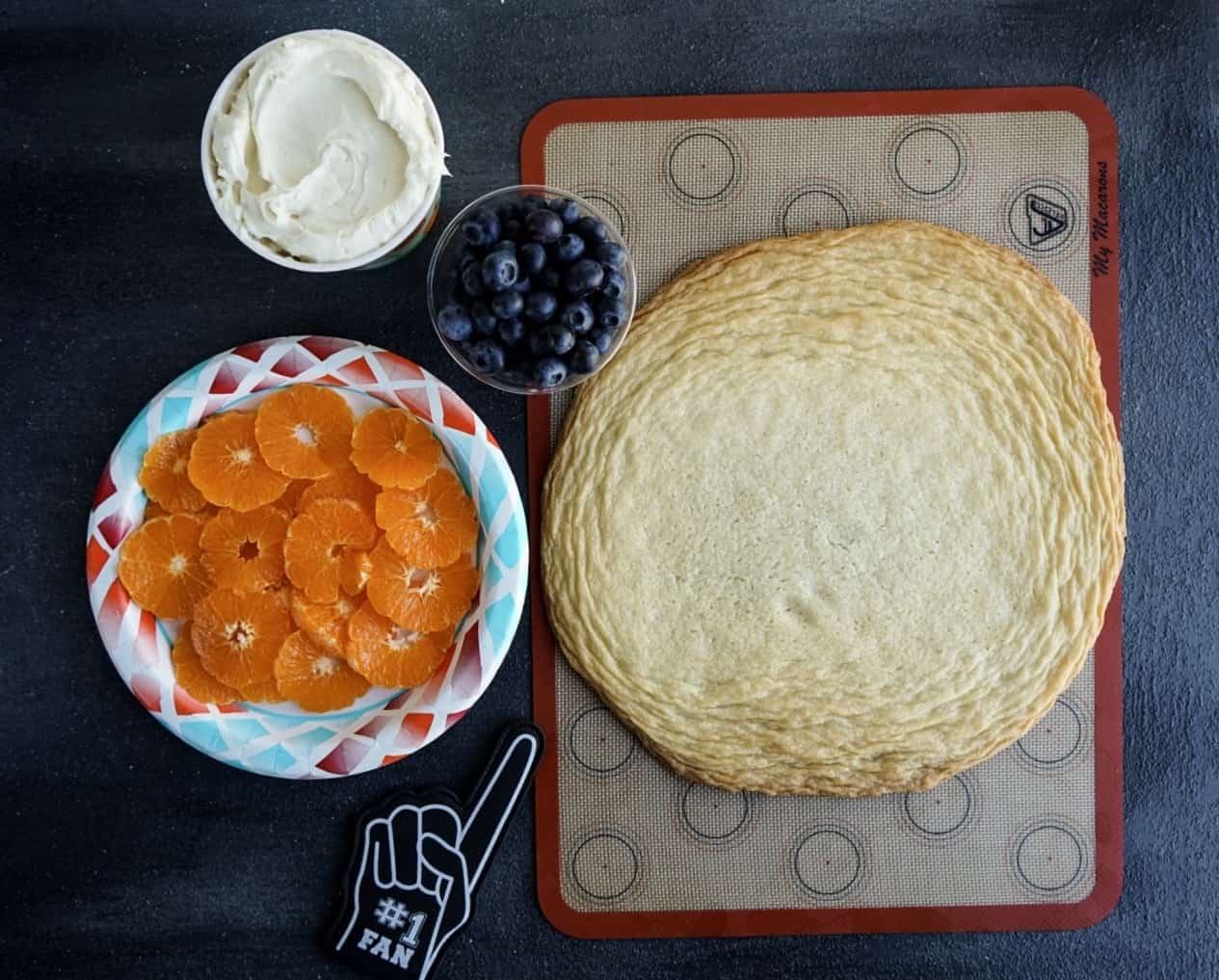 basketball fruit pizza ingredients in cups and on plates ready to assemble