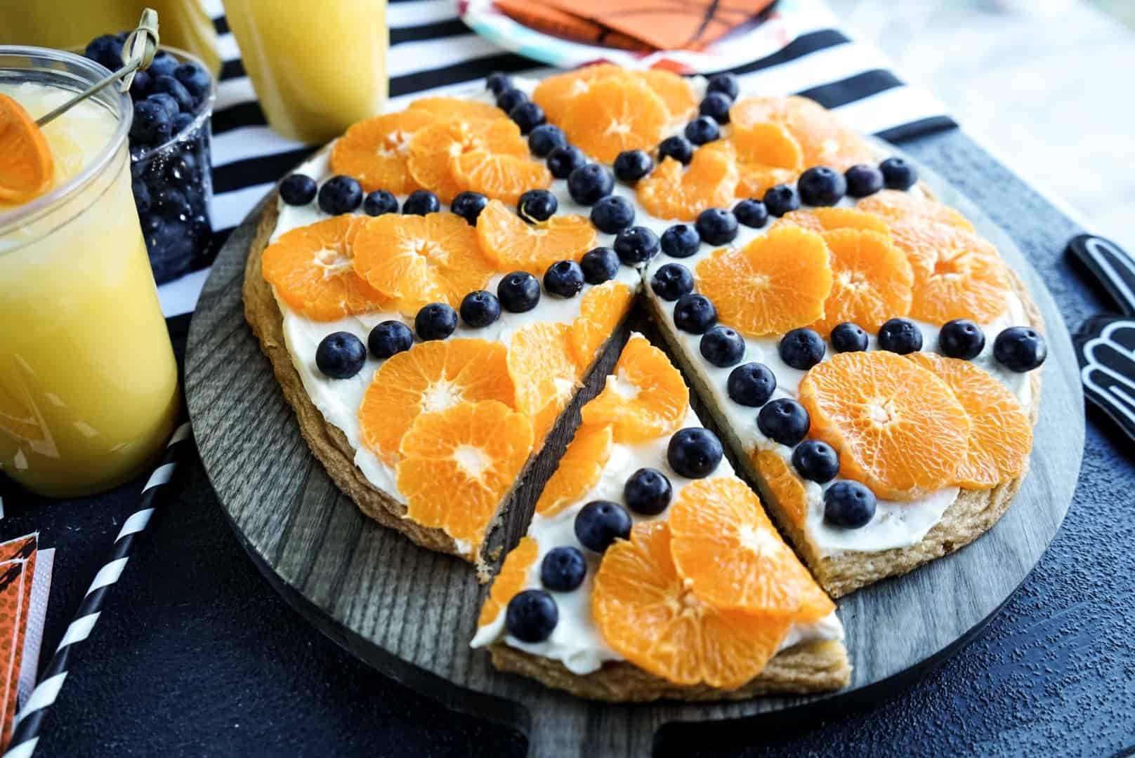 basketball fruit pizza with one slice taken out