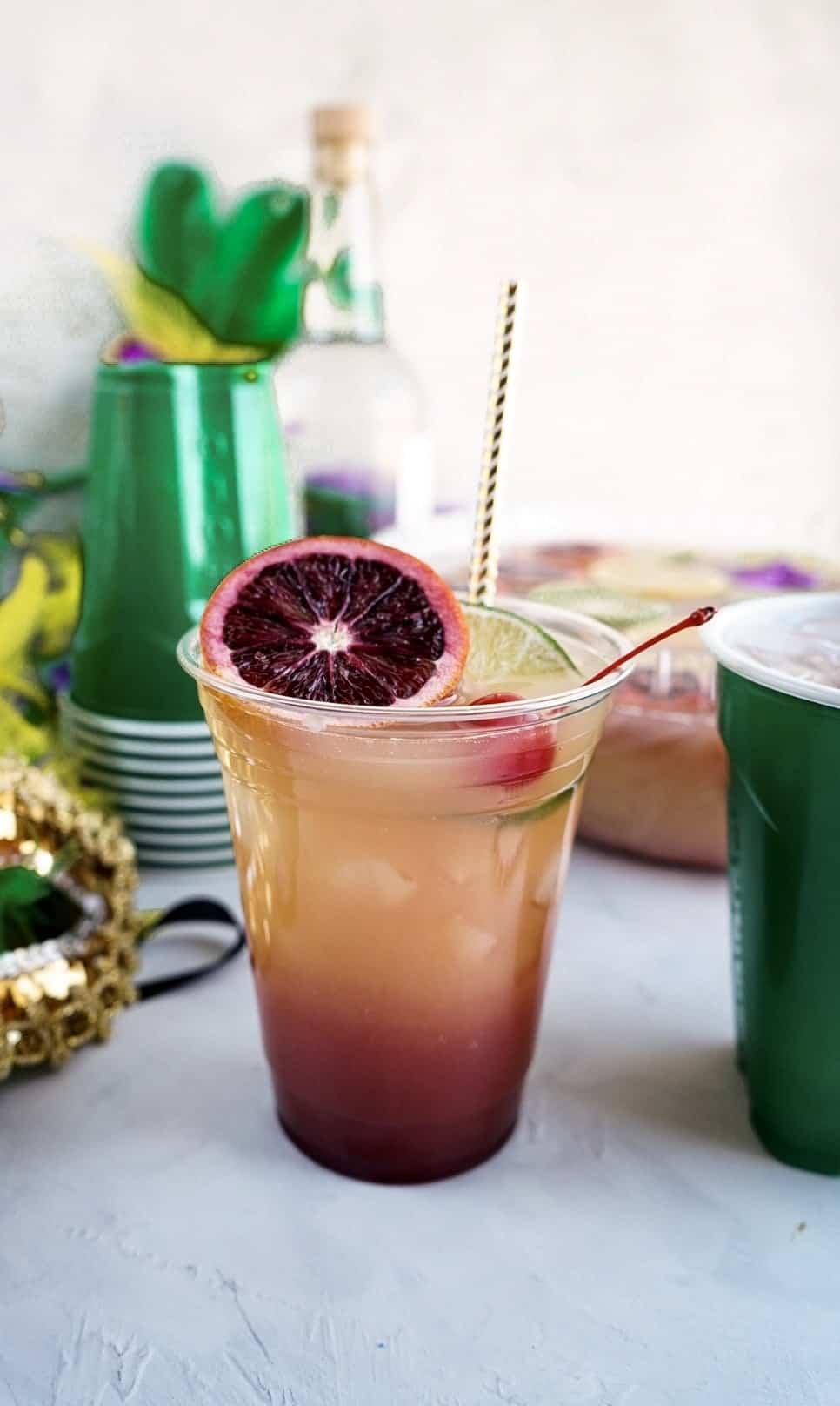 Hurricane Punch bowl in cup garnished with blood orange slice