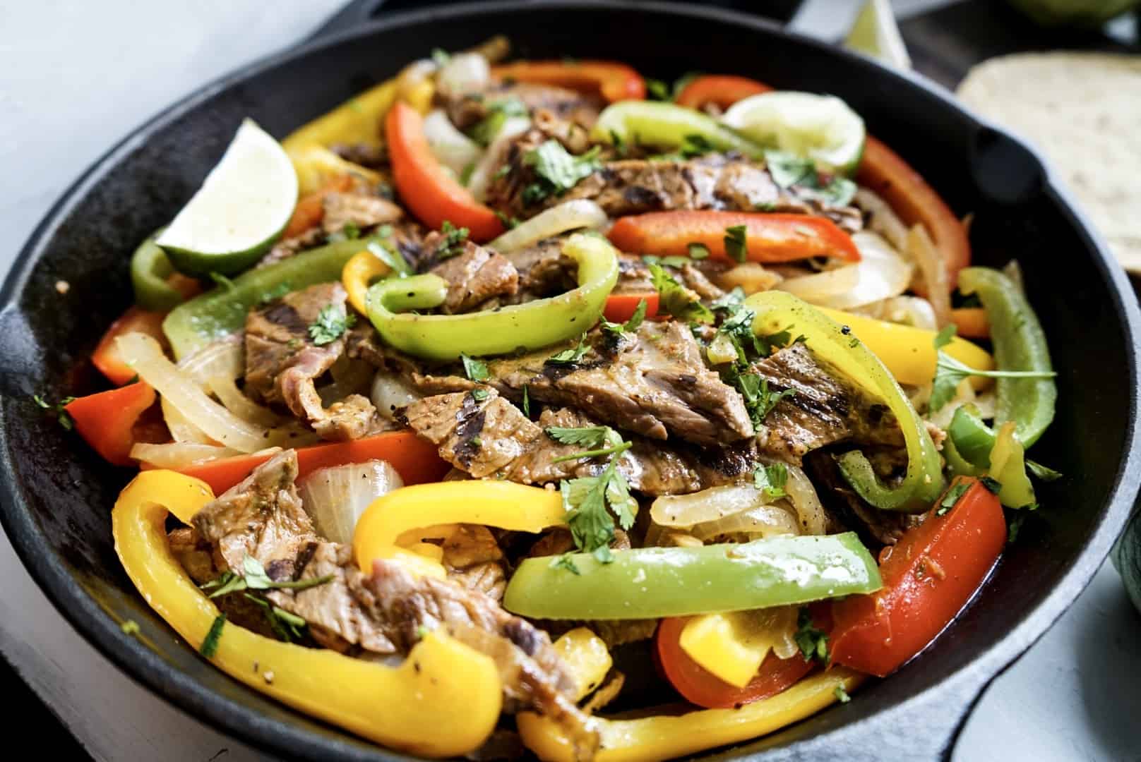 steak fajitas in cast iron skillet