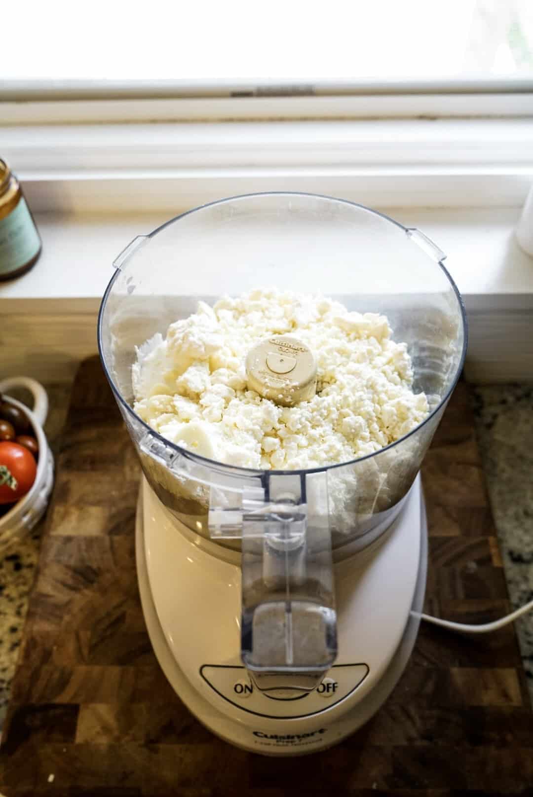 whipped feta dip with sun dried tomato ingredients in food processor