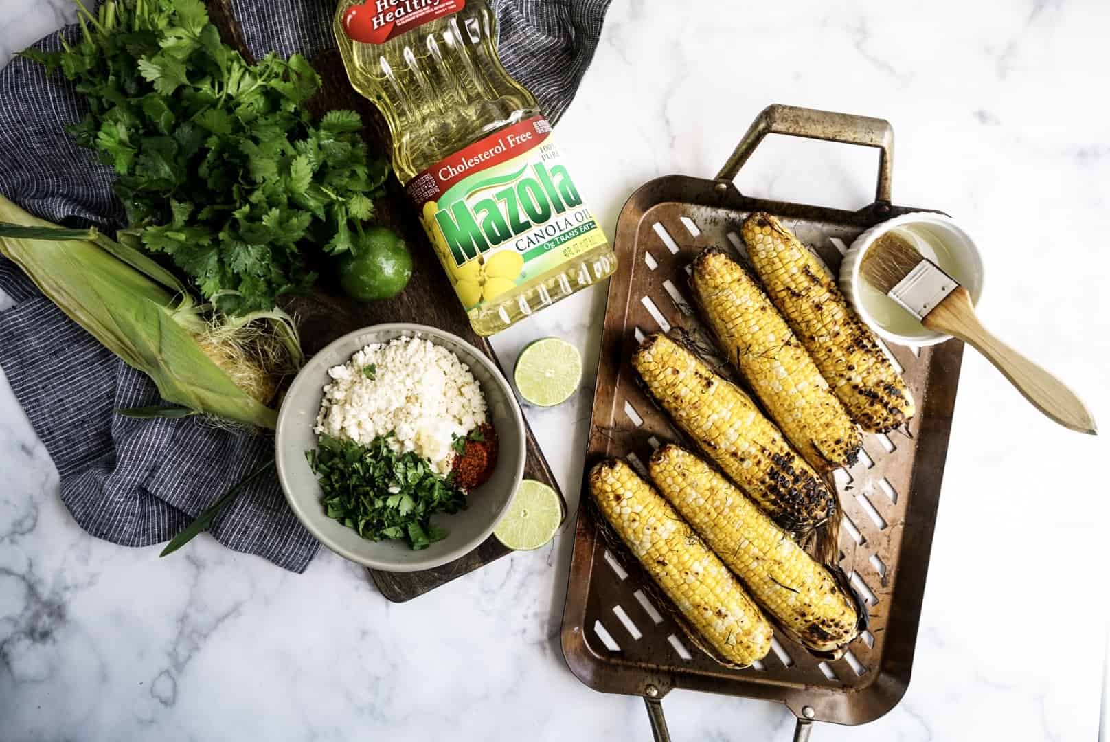 grilled corn with toppings on platter