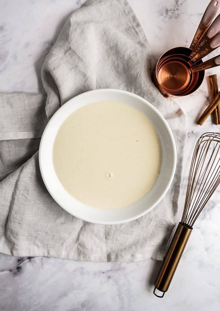 crepe batter in bowl with whisk 