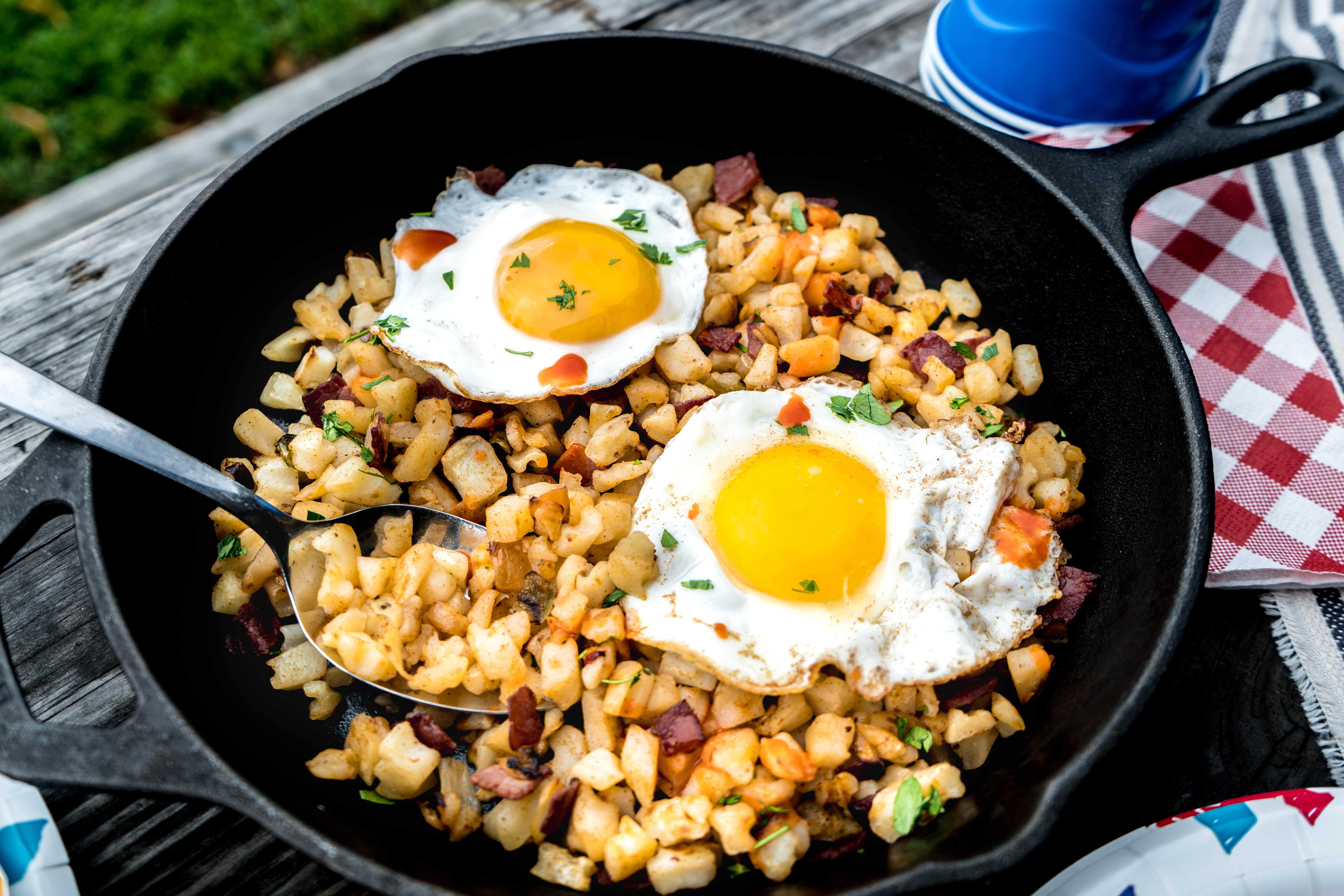 corned beef hash and eggs in skillet