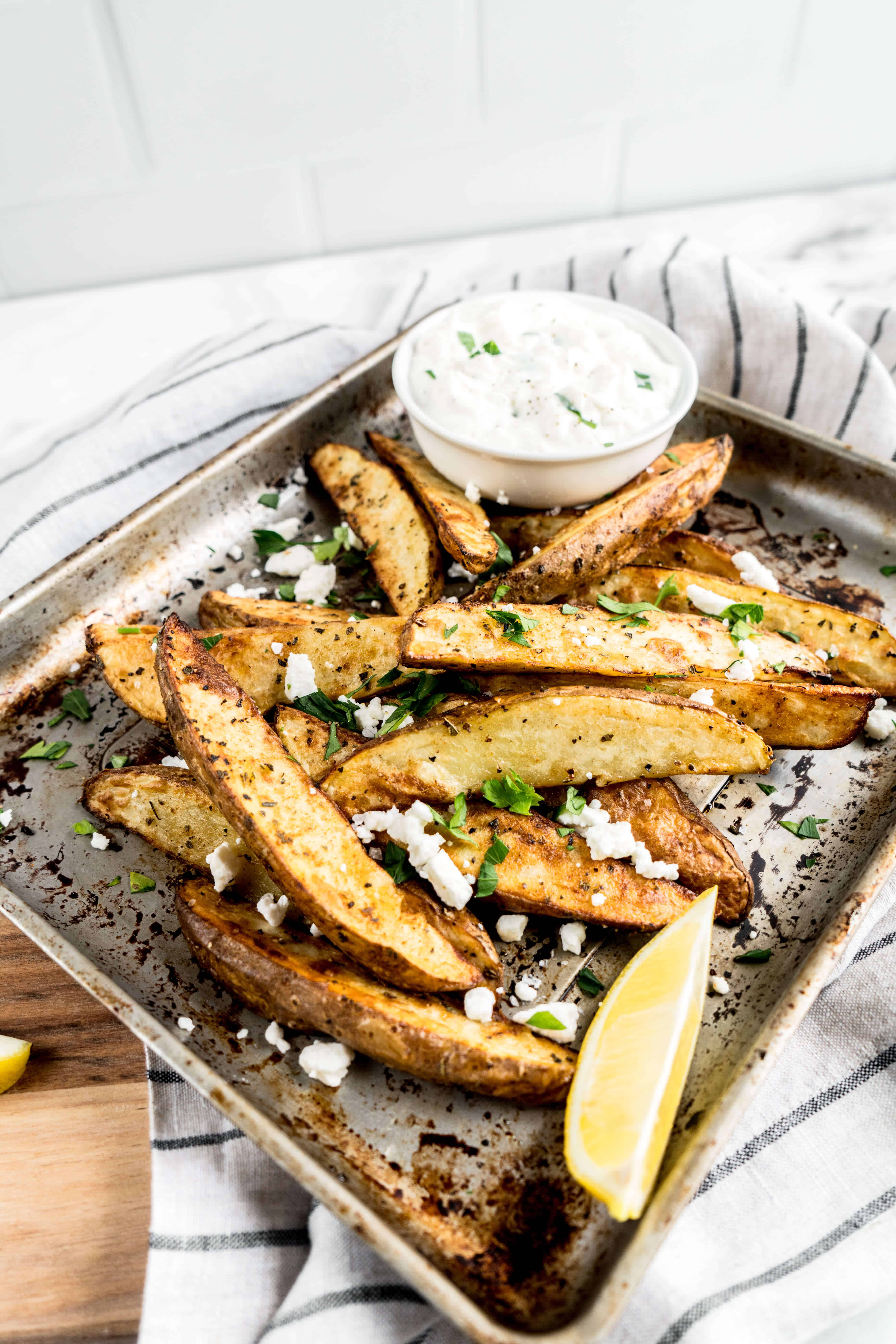 air fryer greek french fries on serving platter with dipping sauce