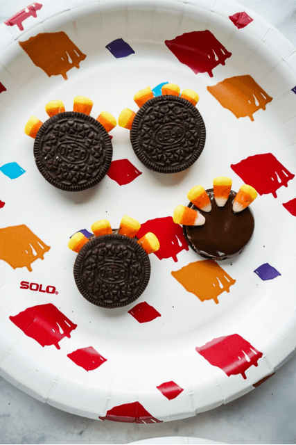 putting the feathers on the double stuffed turkey cookie 