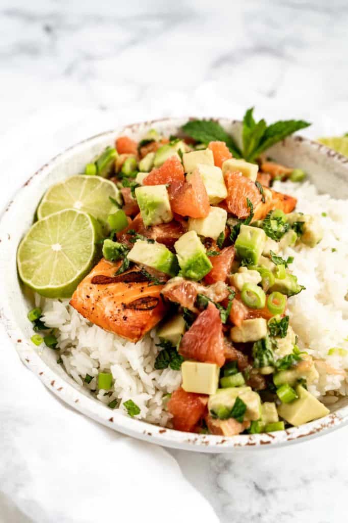 grilled salmon in bowl with grapefruit avocado salsa on top