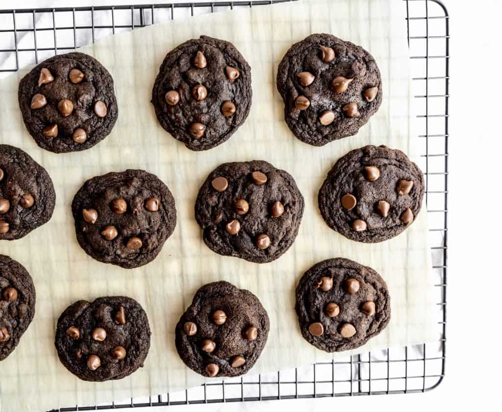 baked double chocolate chip cookies on cooling rack