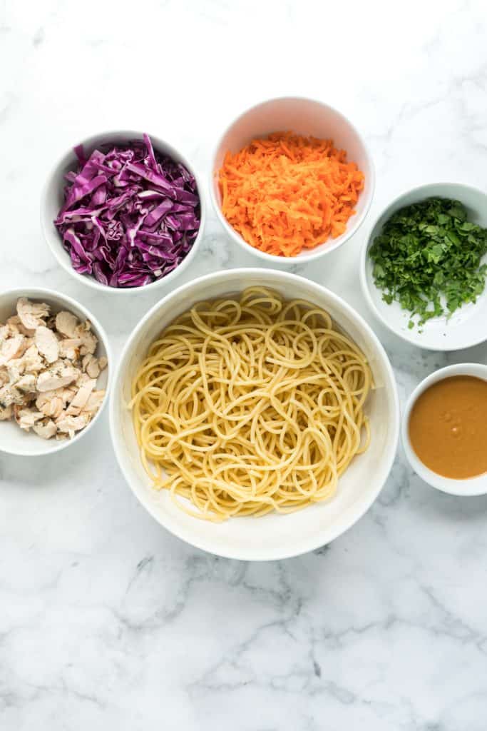 spicy peanut noodle ingredients separated in bowls
