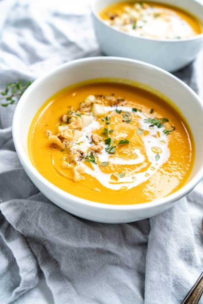 close up shot of garnished carrot apple soup