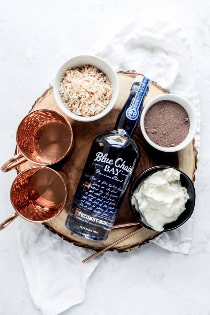 boozy coconut hot chocolate ingredients on wood slab