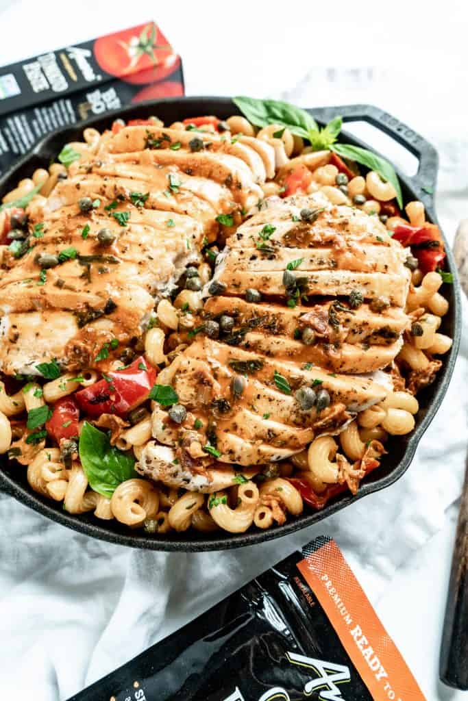 close up shot of creamy roman chicken pasta cooked in skillet