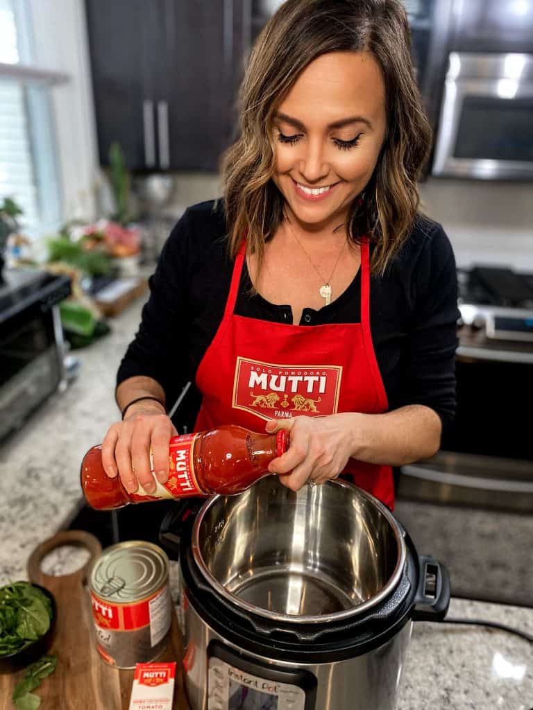 chef making sausage and gnocchi soup in instant pot