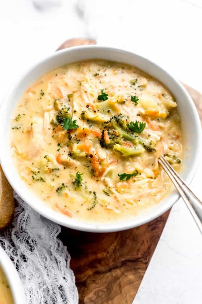 close up shot of broccoli cheddar and chicken soup in bowl with spoon