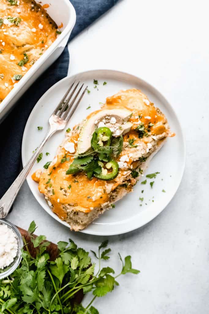 healthier chicken enchiladas on plate with fork