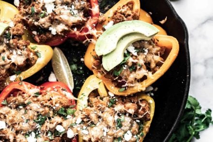 cast iron pan with stuffed peppers and cheese