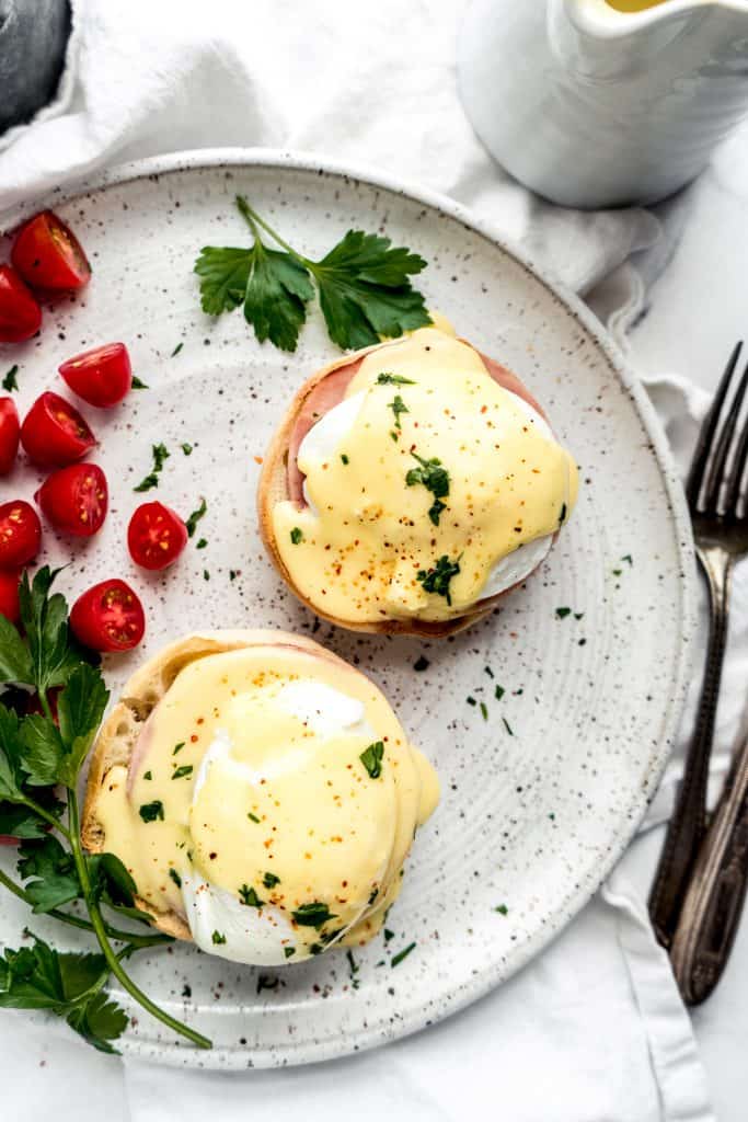 overhead shot of eggs benedict with citrus hollandaise on plate 