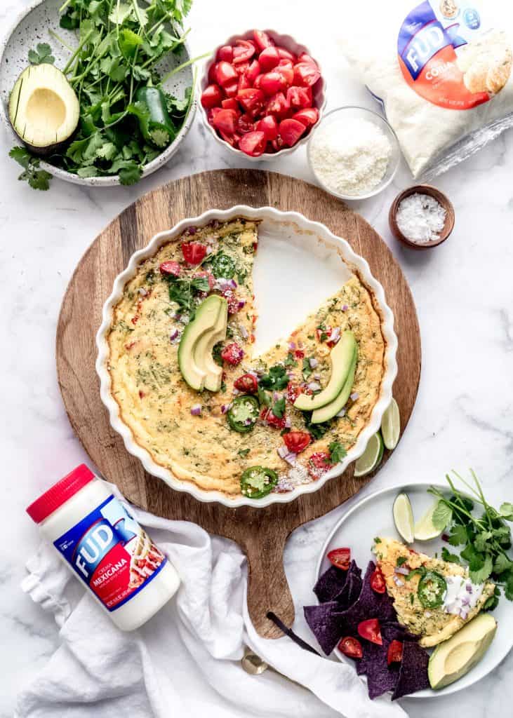 taco frittata in baking dish with slice removed and on plate with garnishes