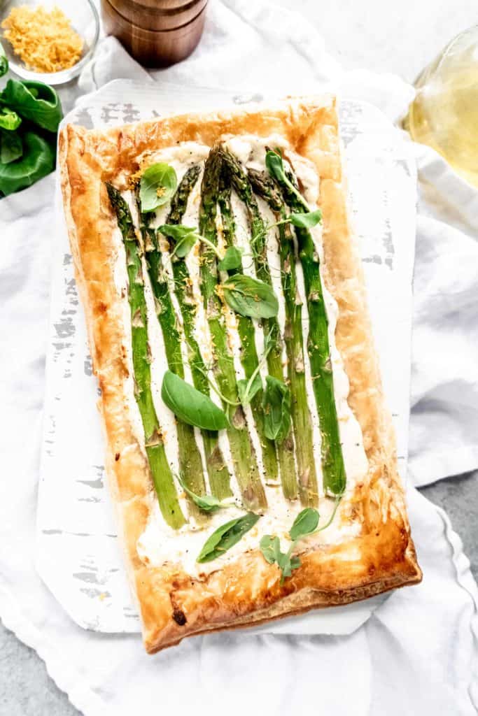 fully baked asparagus goat cheese tart on cutting board