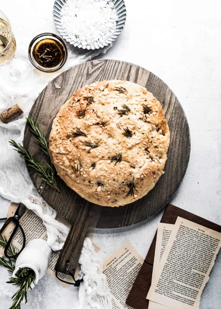 baked asiago rosemary focaccia on cutting board