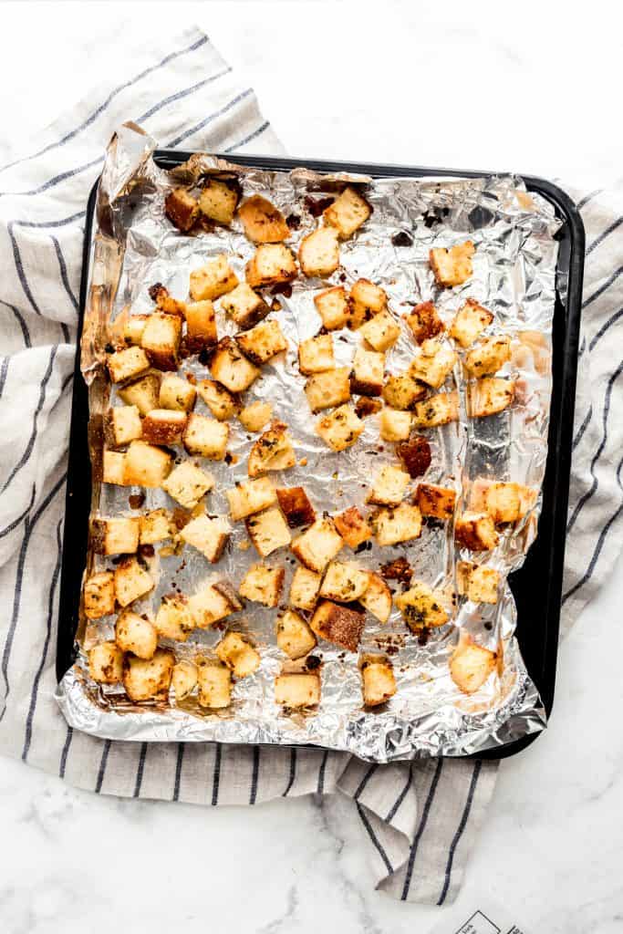 homemade croutons on lined baking tray