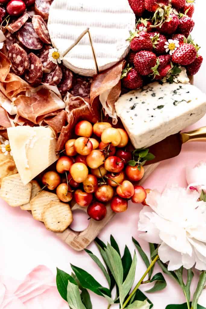 close up shot of cherries and blue cheese on summer charcuterie board