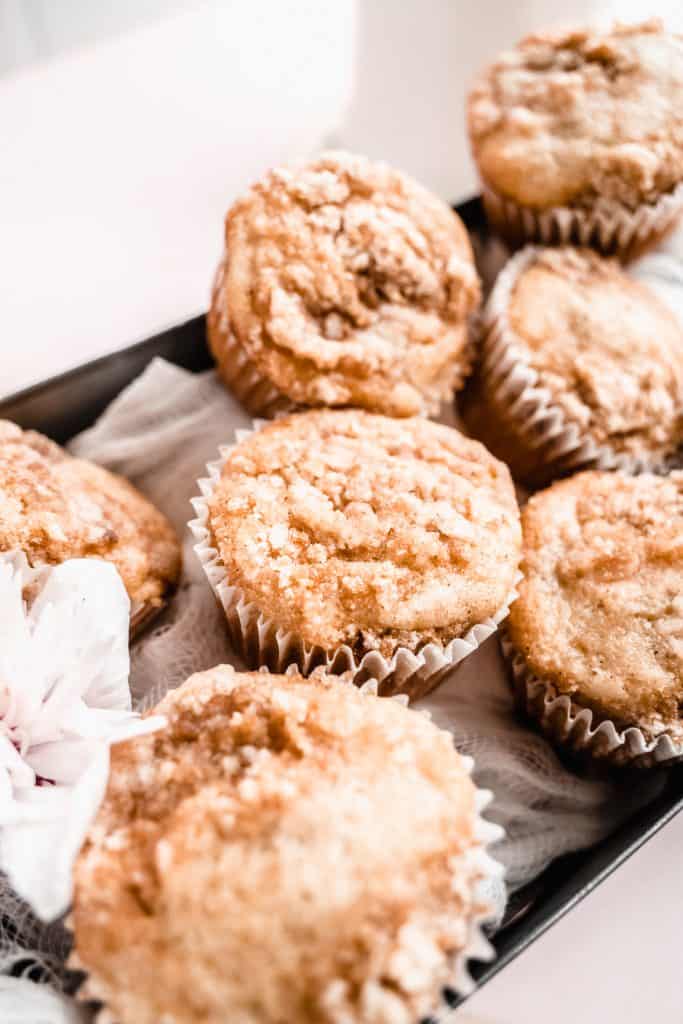 close up of banana streusel muffins in tin box