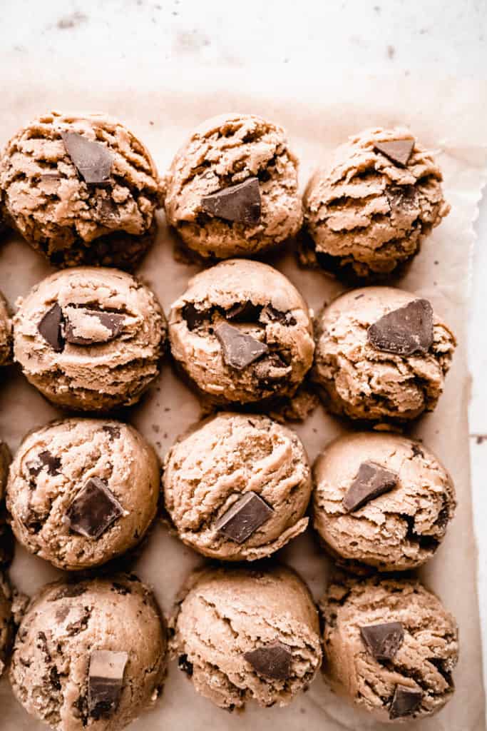 brown butter toffee chocolate chunk cookie dough scoops on parchment paper