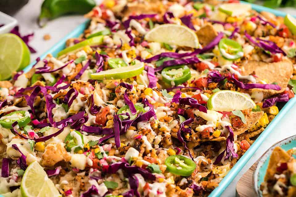 close up view of tilapia nachos on sheet pan 