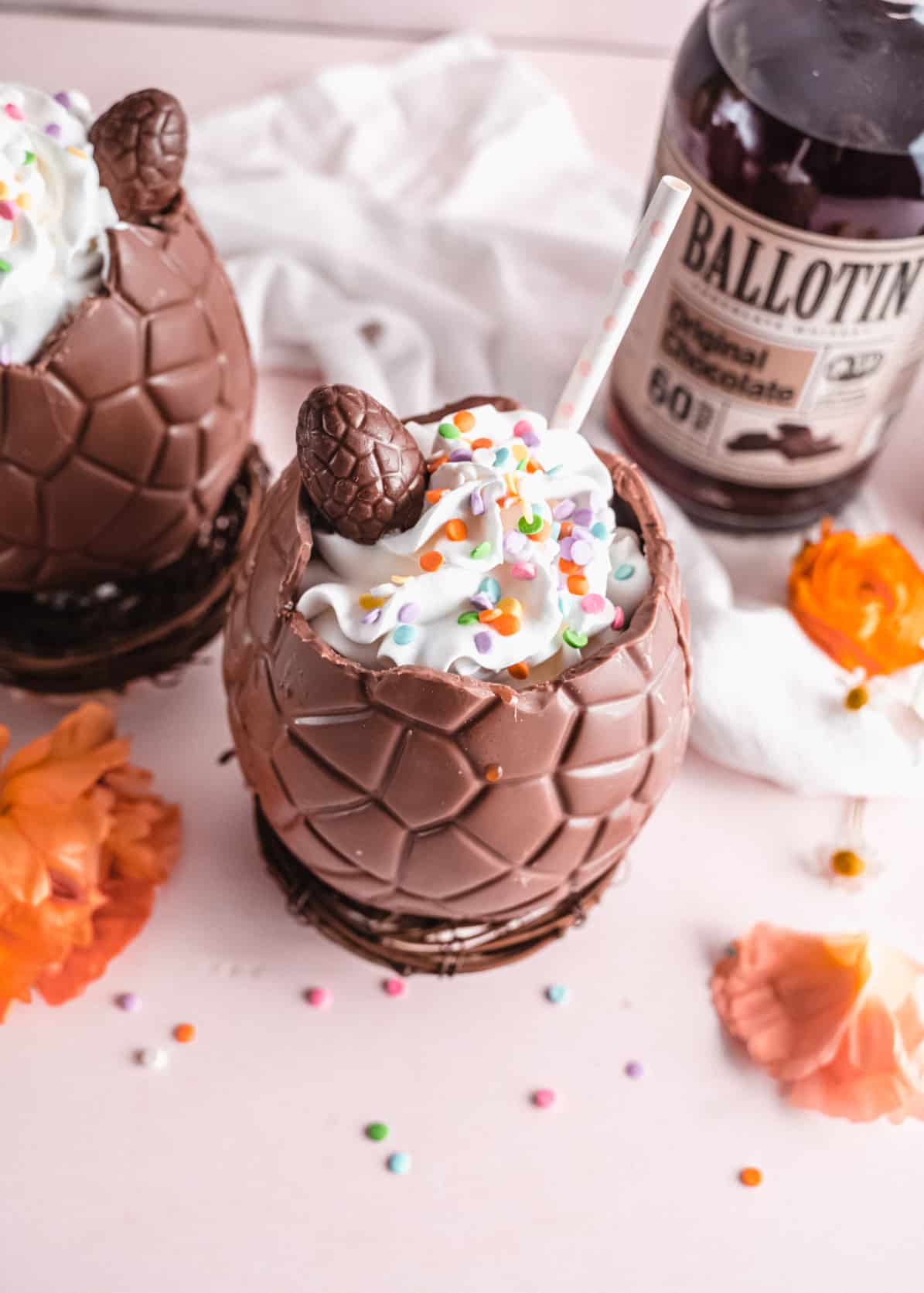 Coffee cocktail in chocolate egg topped with whipped cream and colorful sprinkles 