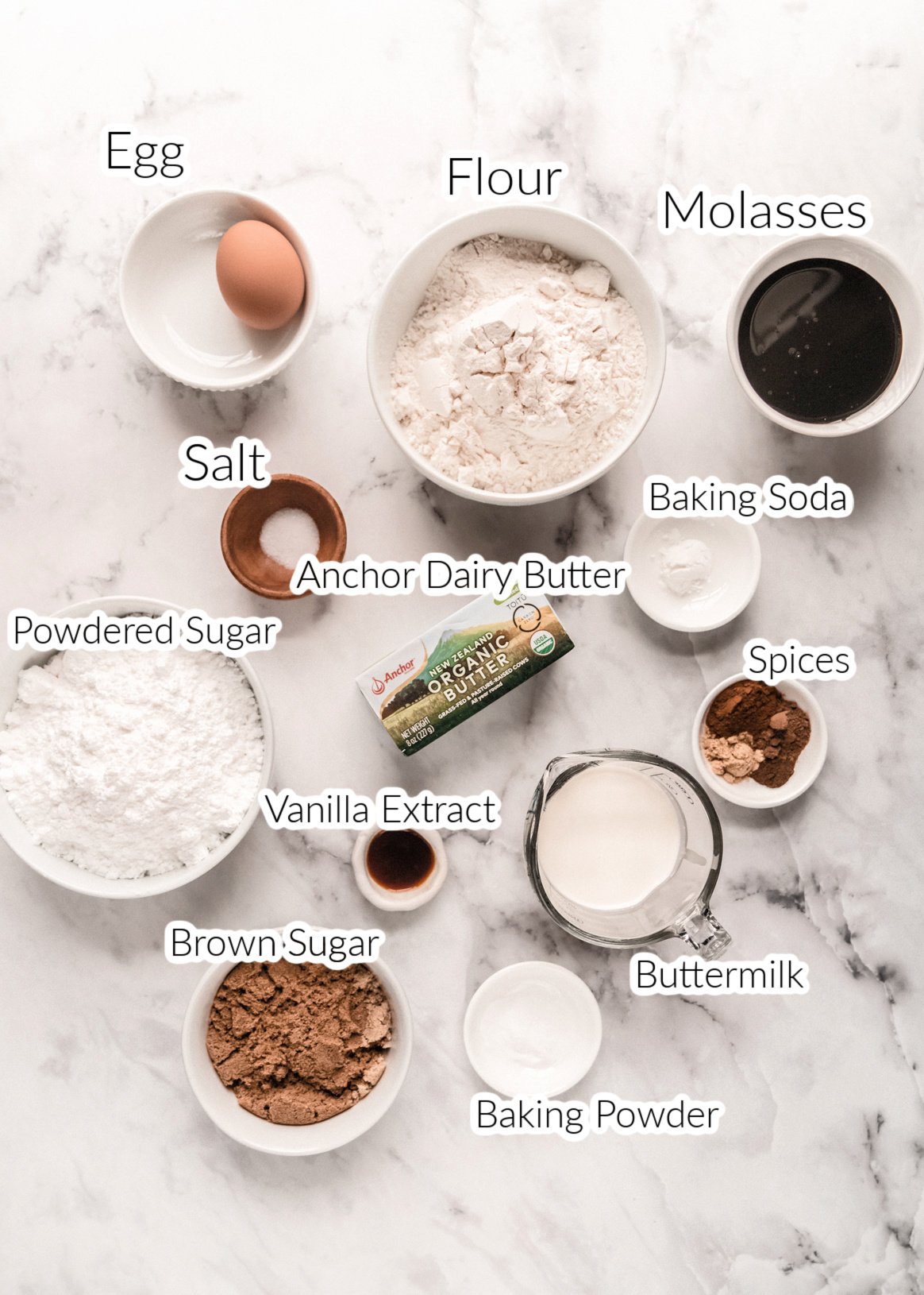 ingredients for gingerbread snack cake in bowl on marble backdrop