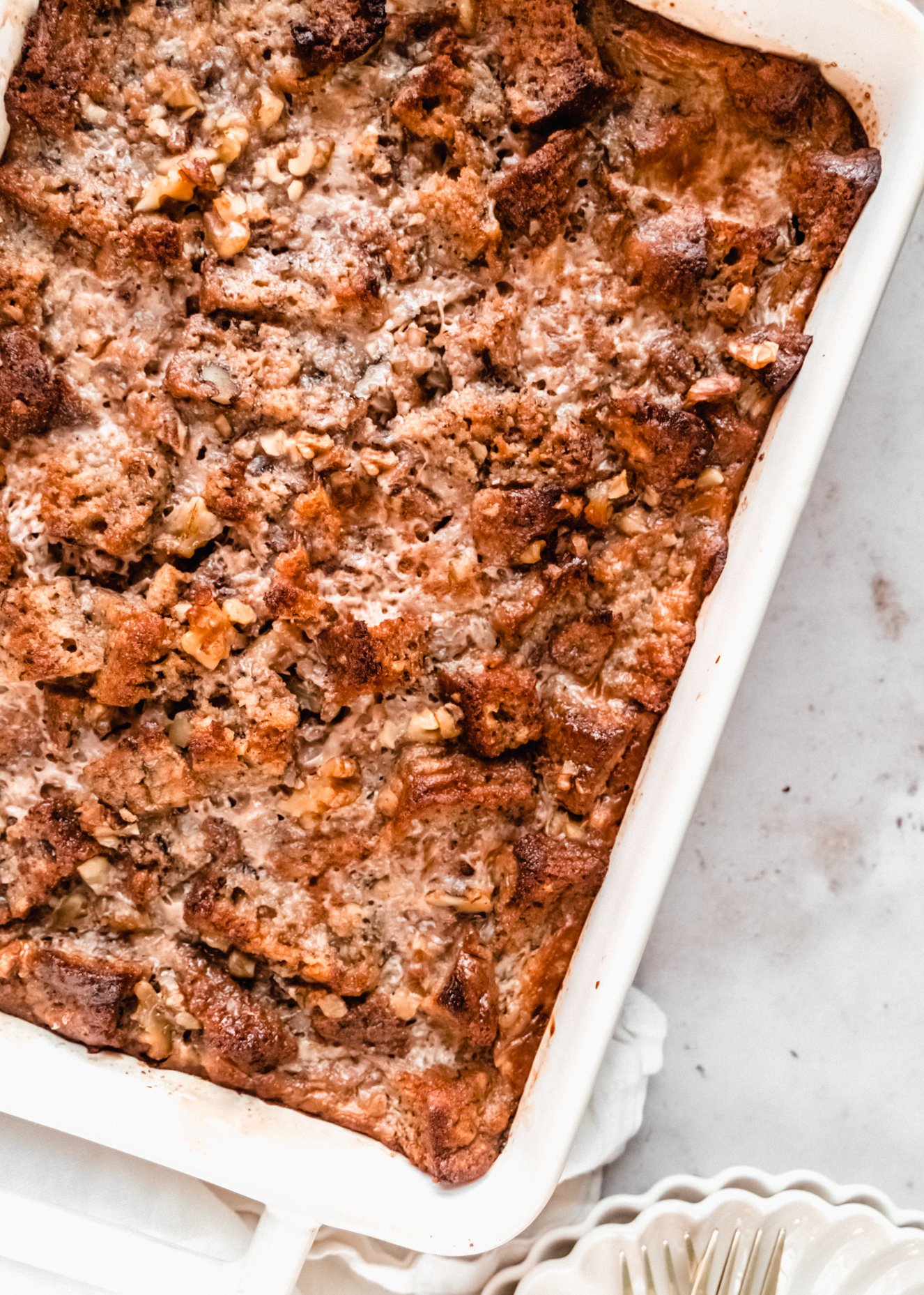 close up of banana bread bread pudding baked in casserole dish 