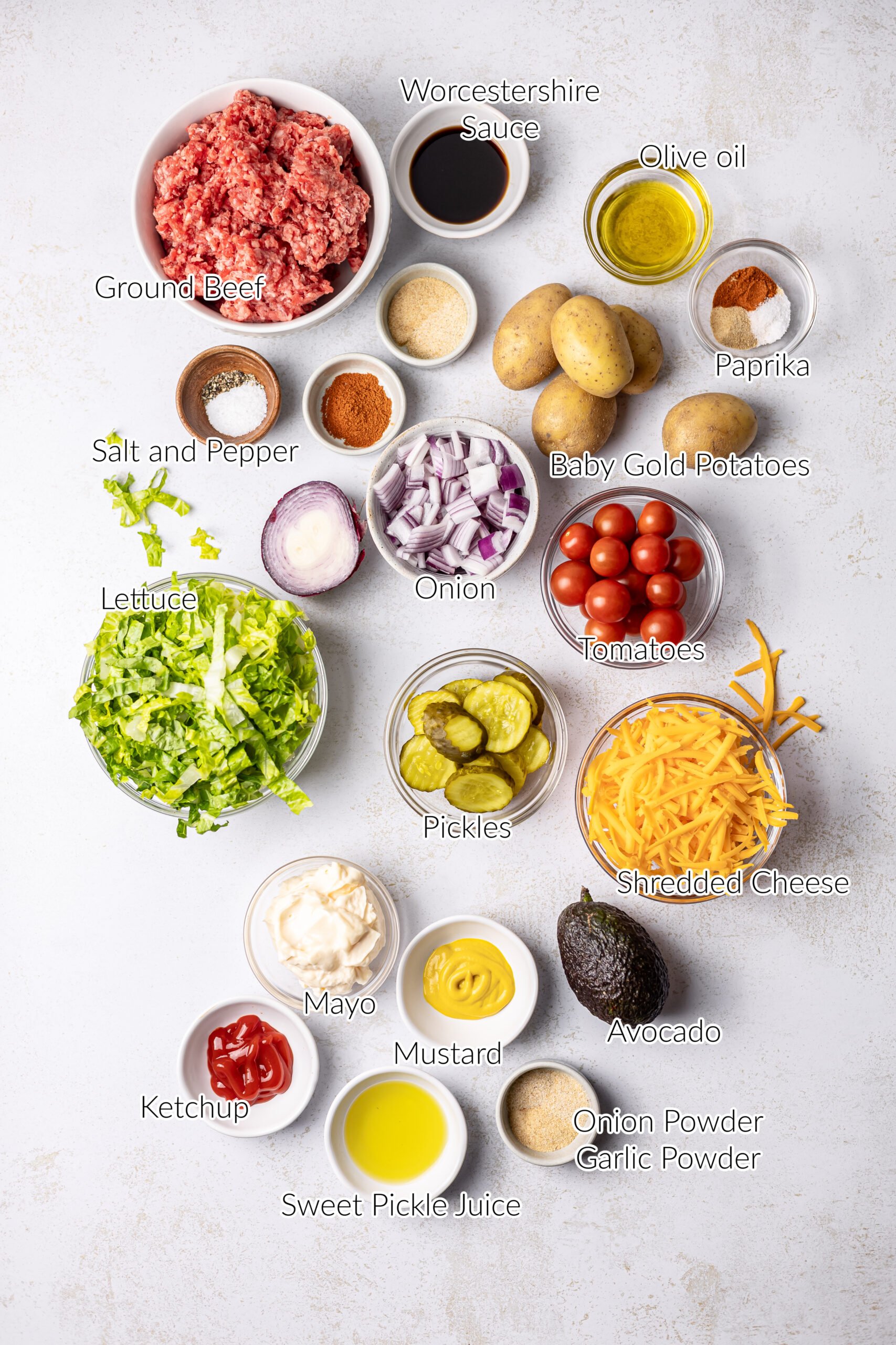 burger bowl ingredients in individual bowls on white countertop
