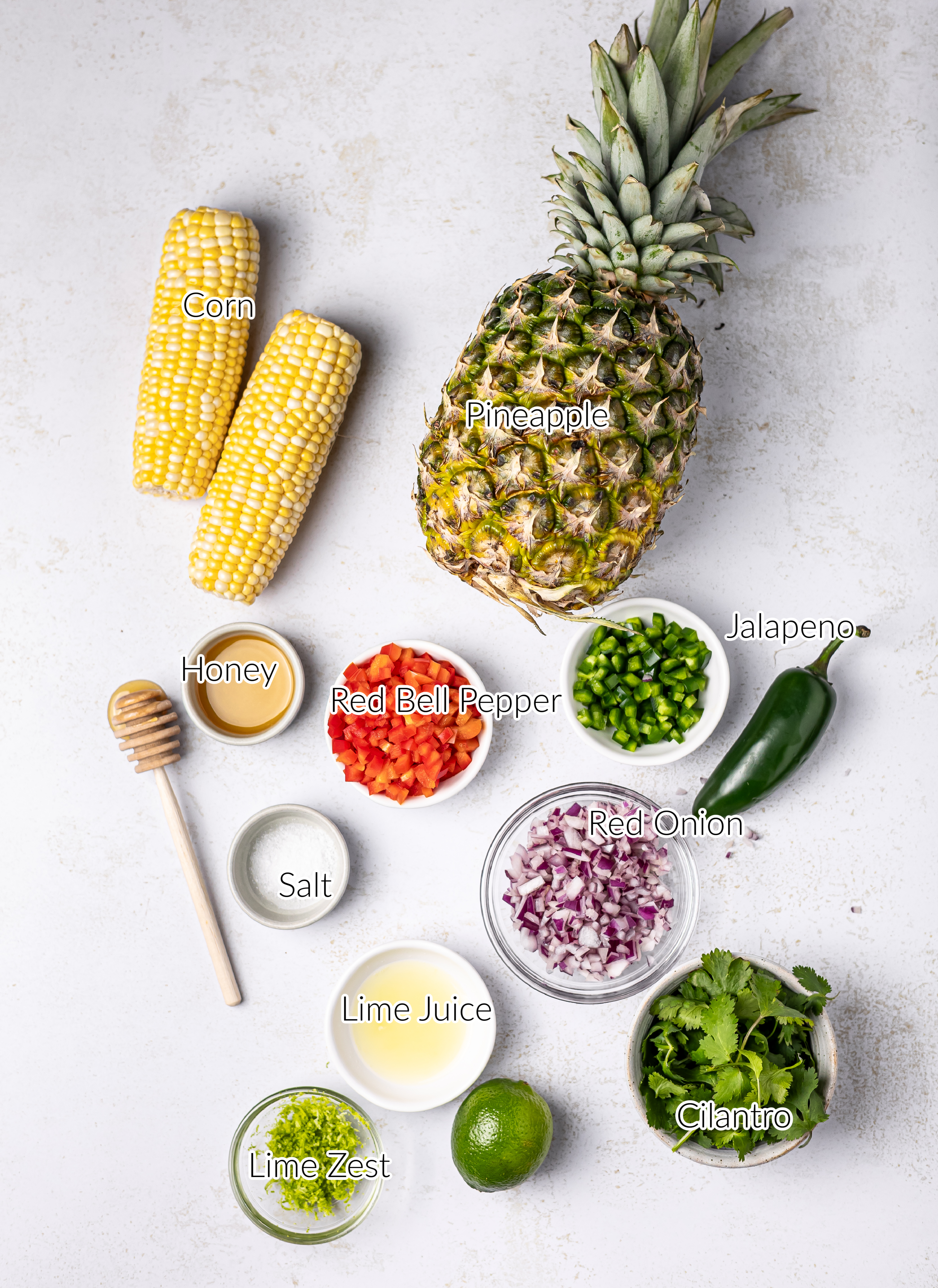 Ingredients for corn and pineapple salsa on a white background